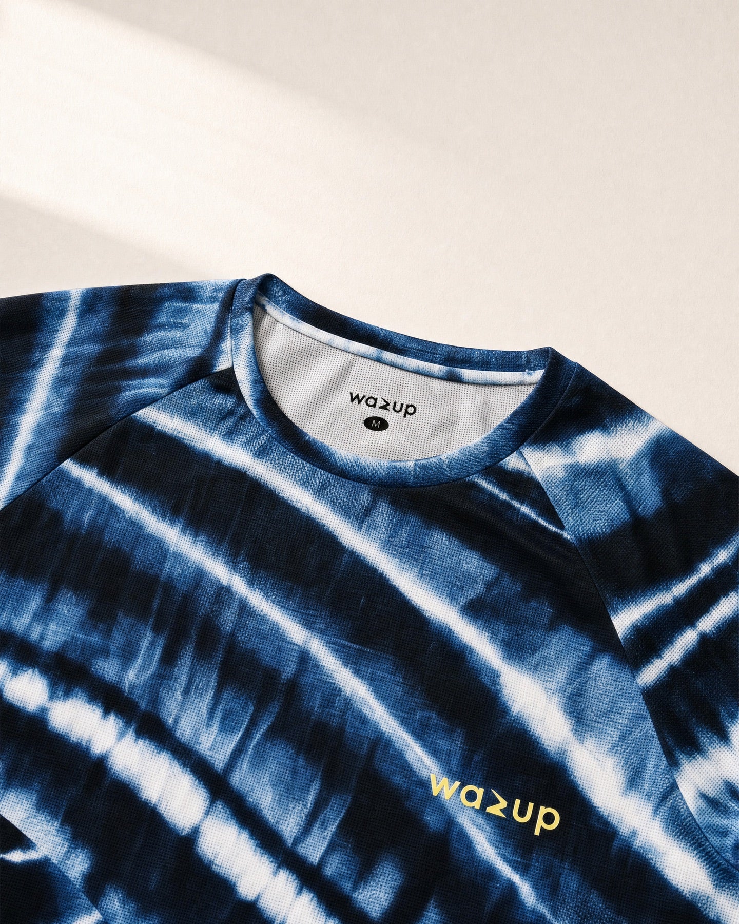 Close product view of the Wave Grid Tee collar, label and shoulder construction